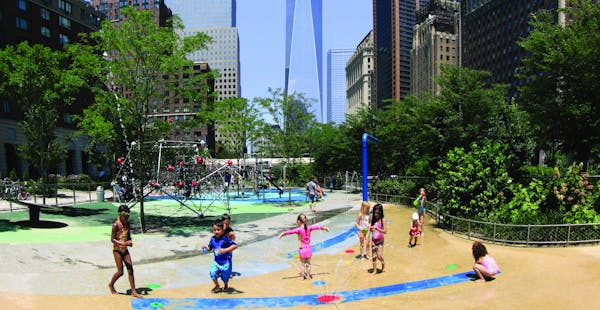 Children playing with One World Trade center in background lower Manhattan New York City